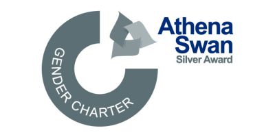 A silver circle that says