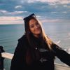 Image of final year undergraduate student Elinor Sullivan standing by the sea.