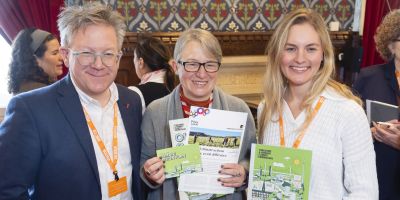 Baroness Natalie Bennett, Holding YHCC flyers and smiling into the camera.