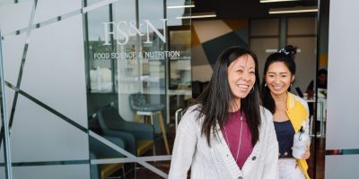 Two people walking out of the School of Food Science and Nutrition