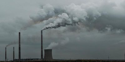 Smoke clouds polluting the air around an industrial plant.