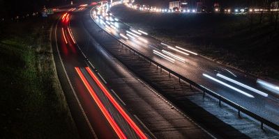 Long-exposure blurred lights from traffic on a road at night