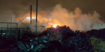 A pile of used car tyres on fire.