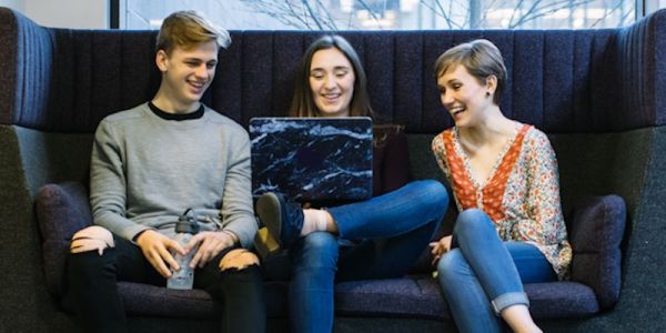 Students chatting on sofa in the School of Earth and Environment.