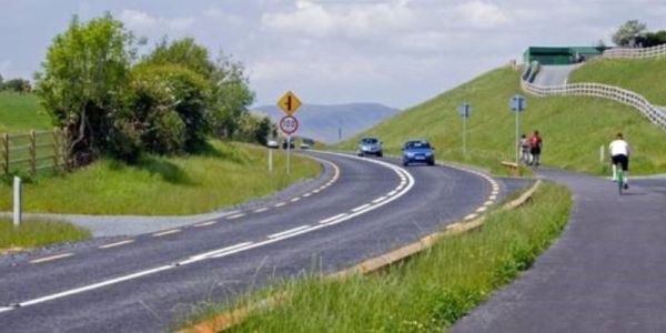 Bike path along side a two-land road in a rural setting.