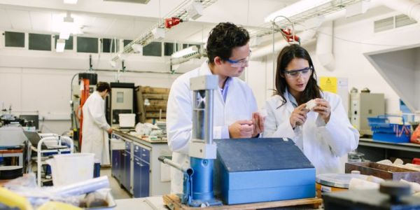 Masters students researching in lab