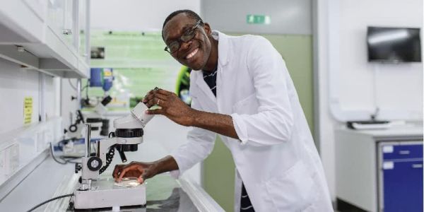 Researcher with microscope