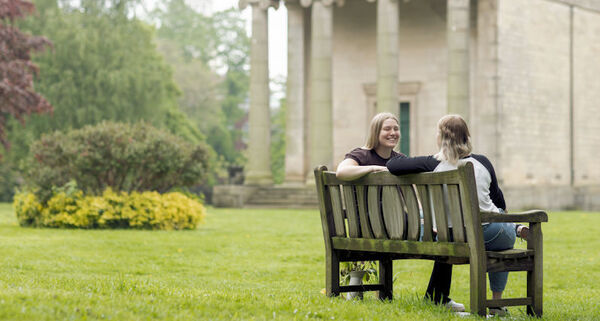 Students sat on a bench in St George's fields