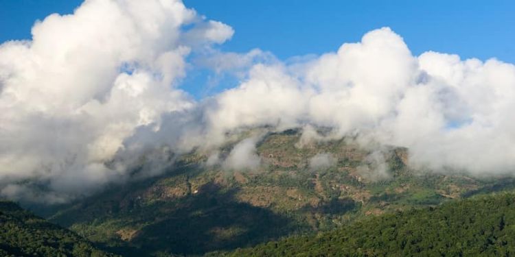 clouds forming over hills